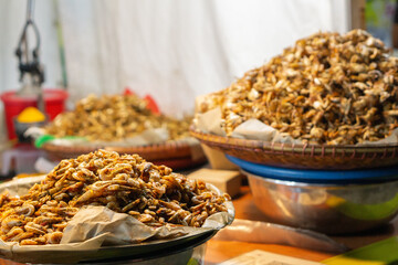Dried shrimp piles at vibrant Asian market stall
