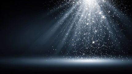 Dramatic light rays with glittering particles in a dark background