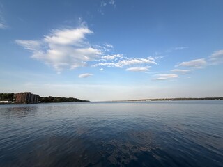 White clouds over a river on a fall day