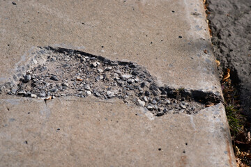 Hole in Sidewalk with Soil and Grass Urban Damage and Nature Breaking Through