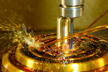 Close up scene the CNC milling machine finishing cut the brass shell mold parts with oil coolant...