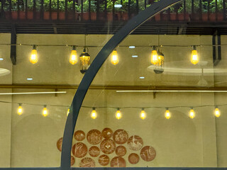 A large round window with a lighted sign hanging from it