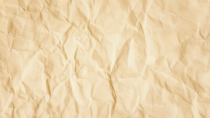 Crumpled light brown paper texture featuring irregular folds and natural wrinkles. This aged, rustic background creates an organic and vintage feel. Ideal for web design, invitations, or graphic pr