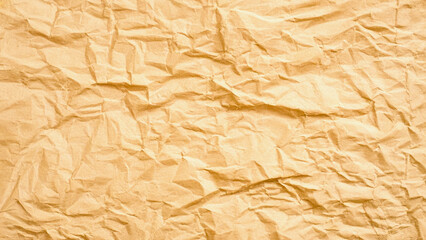 Crumpled brown paper texture background, featuring an uneven, wrinkled surface with natural folds and shadows. Warm, earthy tones create an organic, rustic feel. Perfect for graphic design, packagi