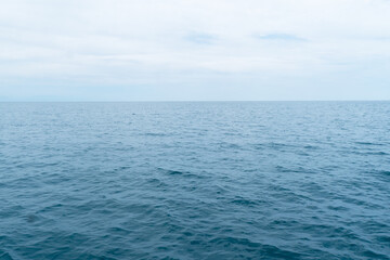 Obraz premium Blue sea water background and sun reflections.. Waves water surface.
