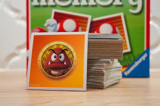 Stack of memory cards featuring animated character Goomba from a popular video game series, displayed with colorful box background