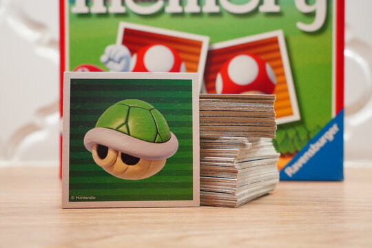 Close-up of a memory card game featuring a turtle shell card from a popular video game on a wooden table