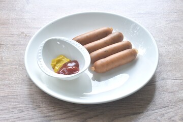 baking smoked Italian pork sausage arranging on plate dipping ketchup and mustard sauce