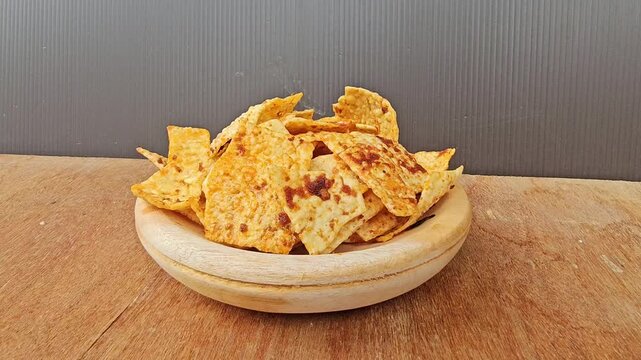 bowl of nachos,Kerupuk or Krupuk Opak balado or Spicy Opak cracker is Indonesian traditional cracker made from cassava dough,crackers coated with chili sauce
