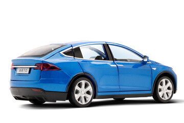 Studio photo of a blue colored modern electric toy car showing the rear view.