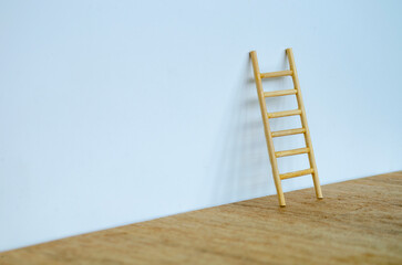 Wooden ladder on white cover background with customizable space for text or ideas. Copy space concept.