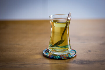 glass of tea with a spoon