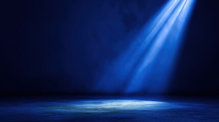 Obraz premium A serene blue-lit space illuminated by a spotlight, creating a calm and focused atmosphere.