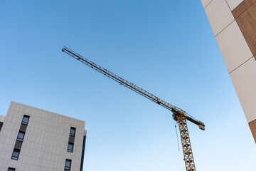 Construction site with crane. Construction crane against blue sky, architecture background, copy space  © Alena