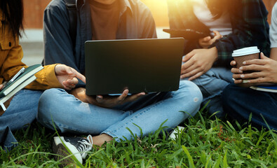 Happy students walking together on university campus, chatting and laughing outdoors after classes