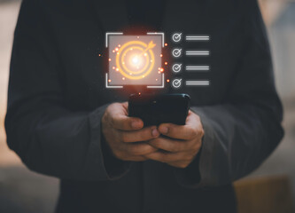 Business planning concept and strategic goal setting and with a businessman pointing at a target icon and checklist. Ideal for success, productivity, project execution and leadership content.