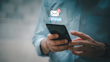 Businessman touching new message notification icon on virtual screen,email alert, online messaging system, representing digital communication, instant response, and business connectivity.