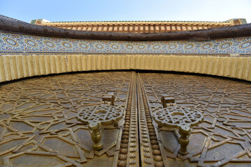 Brass doors adorned with Moroccan patterns, metal filigree, and intricate relief work. Royal Palace, Fez, Morocco