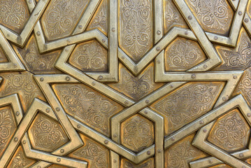 Brass doors adorned with Moroccan patterns, metal filigree, and intricate relief work. Royal Palace, Fez, Morocco