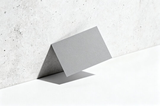 Gray card against concrete wall