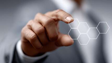 Innovative Touch: A professional's hand interacts with a digital hexagonal design, symbolizing innovation and connection in the realm of modern technology. 