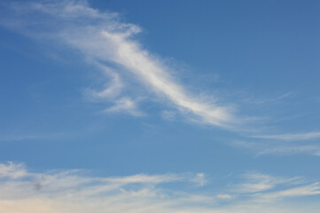 sky background featuring delicate cirrus clouds drifting across a vibrant blue atmosphere