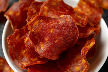 Spanish Chorizo Crisps in a white bowl. A high protein snack.