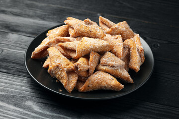 Angel Wings, Faworki, cakes. sweet pastry deep fried and sprinkled with powdered sugar.