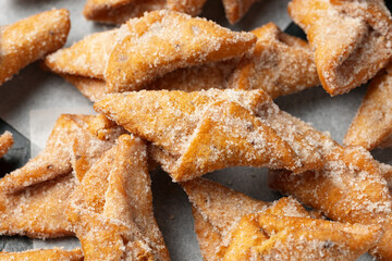 Angel Wings, Faworki, cakes. sweet pastry deep fried and sprinkled with powdered sugar.