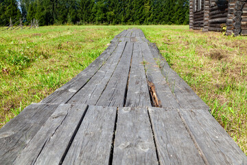 Fototapeta premium Old Wooden Plank Walkway in Village, Close-Up