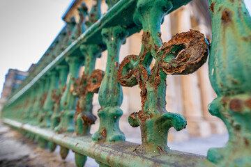 Rusty Green Iron Fence Detail by Historic Stone Building