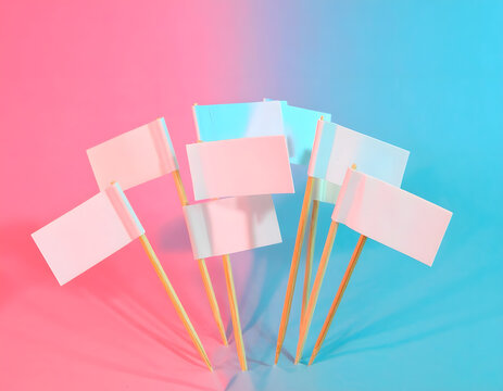 Small pink cake flags on sticks with blank paper labels