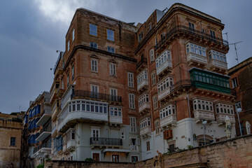 Historic Apartment Blocks with Enclosed Wooden Balconies and Weathered Facades