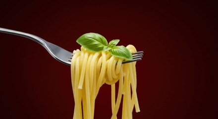 Delicious spaghetti on fork with fresh basil leaves against a rich dark red background perfect for culinary themed projects