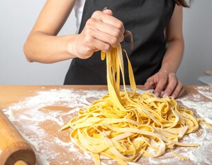 Homemade fresh tagliatelle pasta making process with flour and rolling pin.