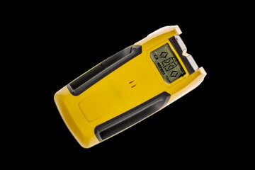 Electrical wiring detector isolated on black background, close-up, top view.