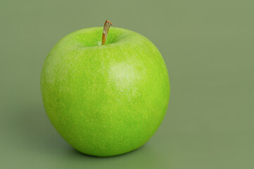 Green apple on a green background. Fruit, apple.