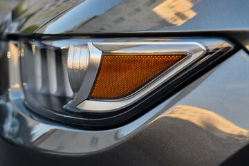 Close up of modern car headlight detail in sunlight