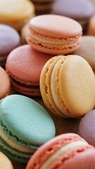 Obraz premium Colorful macarons arranged closely together, showcasing various pastel shades and smooth textures.
