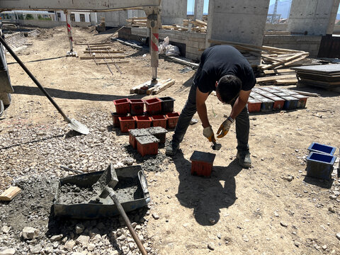 Engineers conducting slump tests for concrete strength.