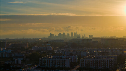 A distant view of Warsaw’s skyscrapers on a foggy autumn morning.
