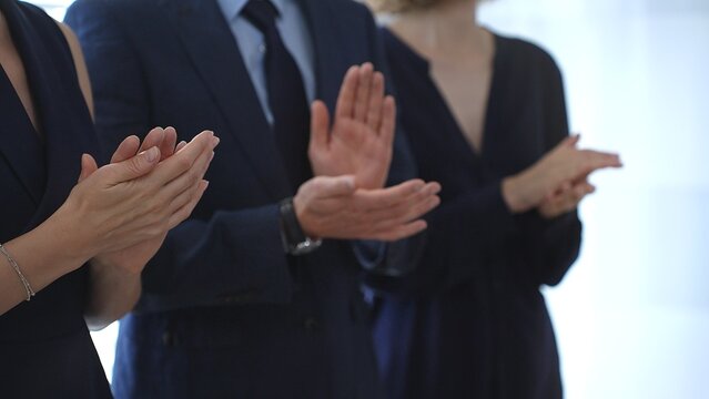 Business people are clapping hands, expressing gratitude and acknowledging a successful performance or presentation, creating a positive and encouraging atmosphere in a professional setting