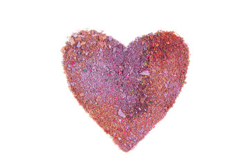 A multicolored pink heart made from scattered eyeshadow powder isolated on white background.