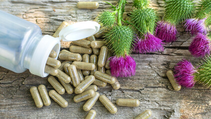 Milk thistle supplements in nature. Selective focus.