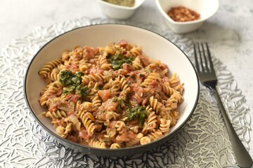 Red lentils fusilli pasta with peeled chopped tomatoes caramelized onion garlic spinach herbs and crushed dried red chillies.