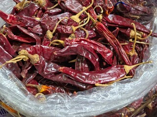 Close-up of a heap of whole dried red chili peppers.