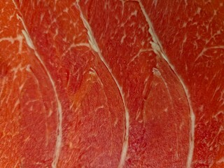  Close-Up of Thinly Sliced Raw Beef Brisket.