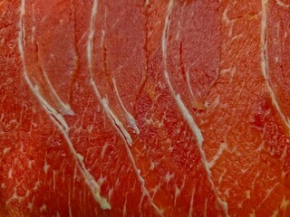  Close-Up of Thinly Sliced Raw Beef Brisket.