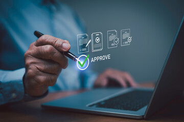 Businessman using digital pen approving online documents on laptop with virtual check mark icon. Concept of electronic signature, document approval, digital workflow, and business technology.