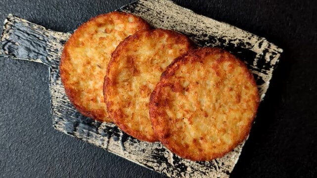 Potato hash browns, a cooked vegetable breakfast food. Potato hash browns as a food background for your design